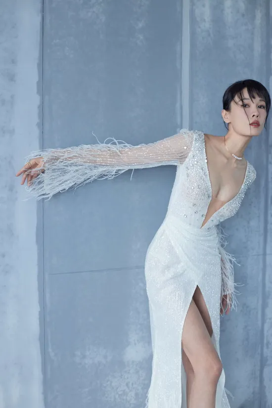 Model Zoe Zhang in a high-fashion feathered couture gown with a high slit, a result of our collaboration with a visionary designer.