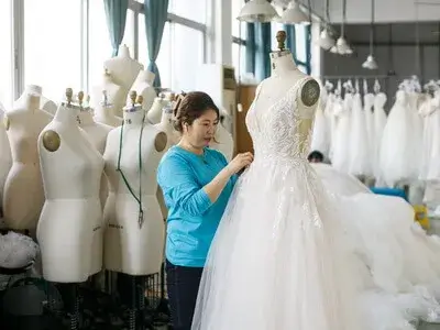Final quality control check and fitting inspection on a mannequin.